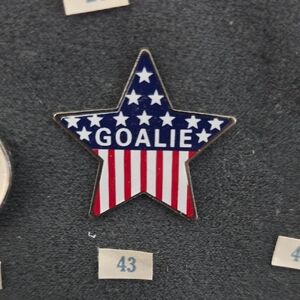 Star-Shaped Goalie Pin with American Flag Design